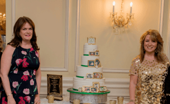 two women with large cake