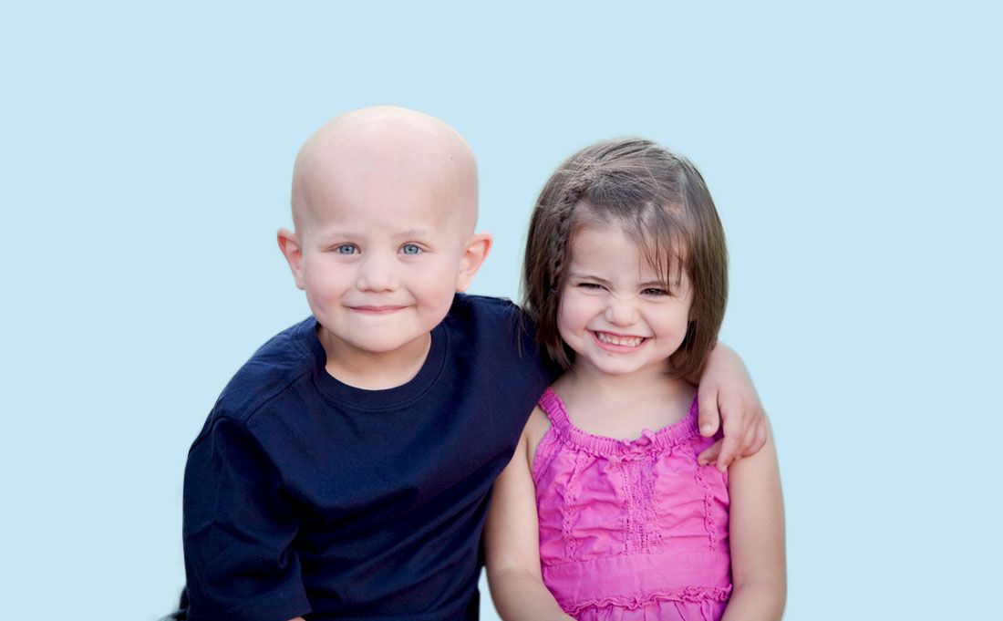 Young boy with his arm around a young girl