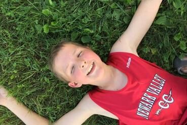 Honored Kid Brody laying in grass