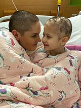 Honored Kid Mia and her mother in bed with shaved heads