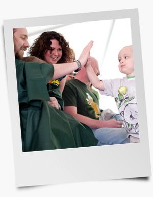 Shavee participant high fiving a young boy